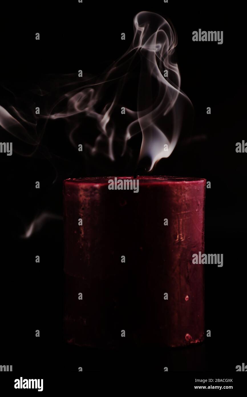 studio shot of Black Cherry Candle smoking, black background Stock