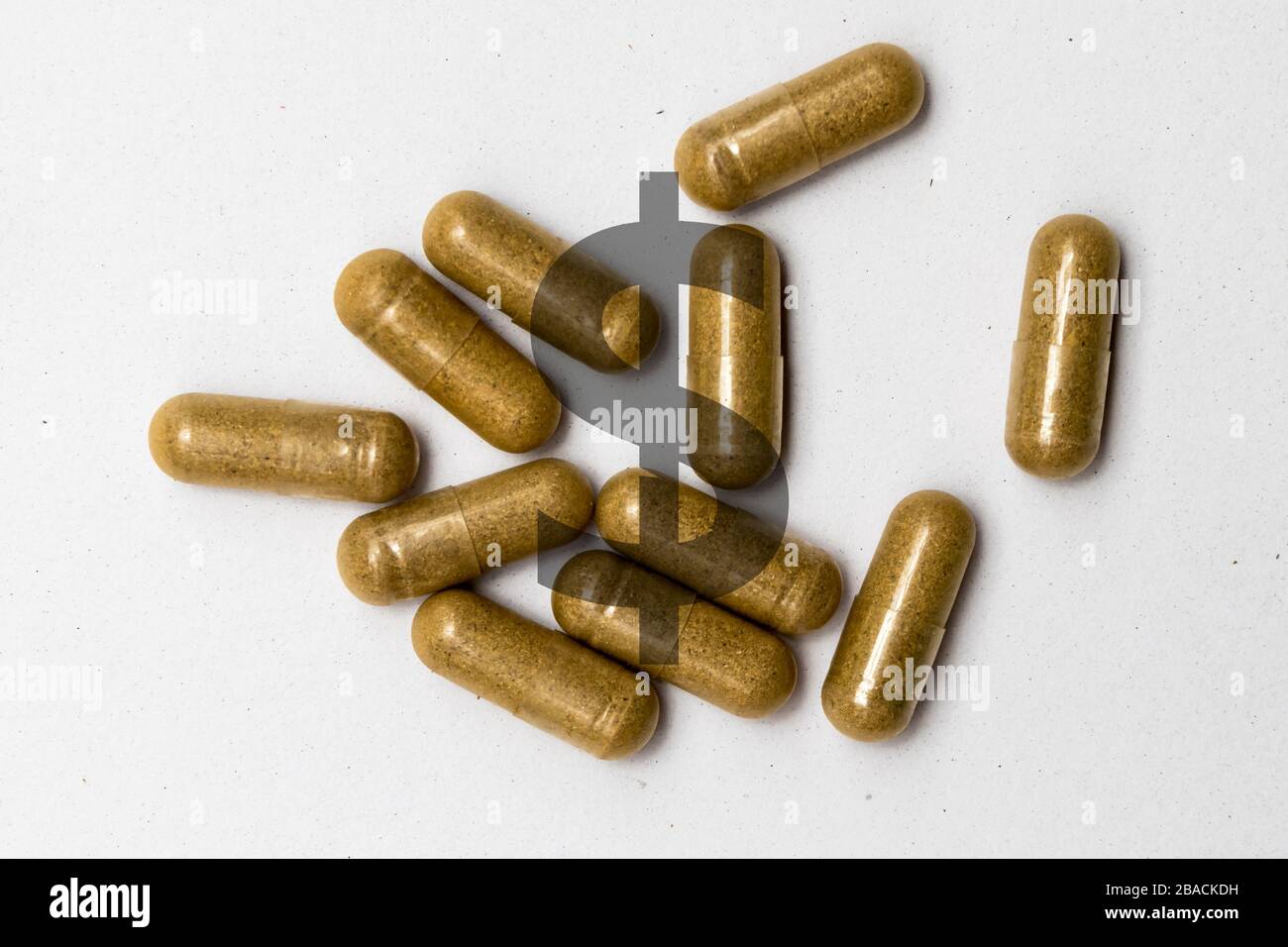 Slow release capsules on a white background with dollar sign illustrating cost of prescription drugs Stock Photo