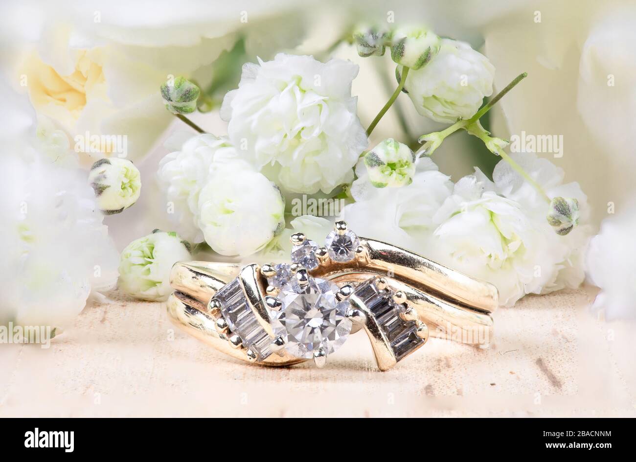 Diamond wedding ring splay with white baby's breath flowers Stock Photo