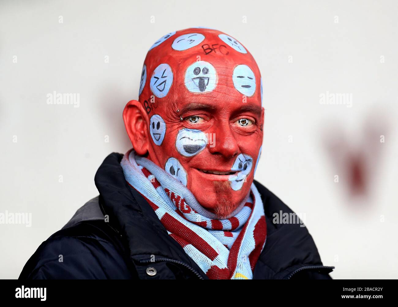 A Burnley fan with emoji facepaint Stock Photo Alamy