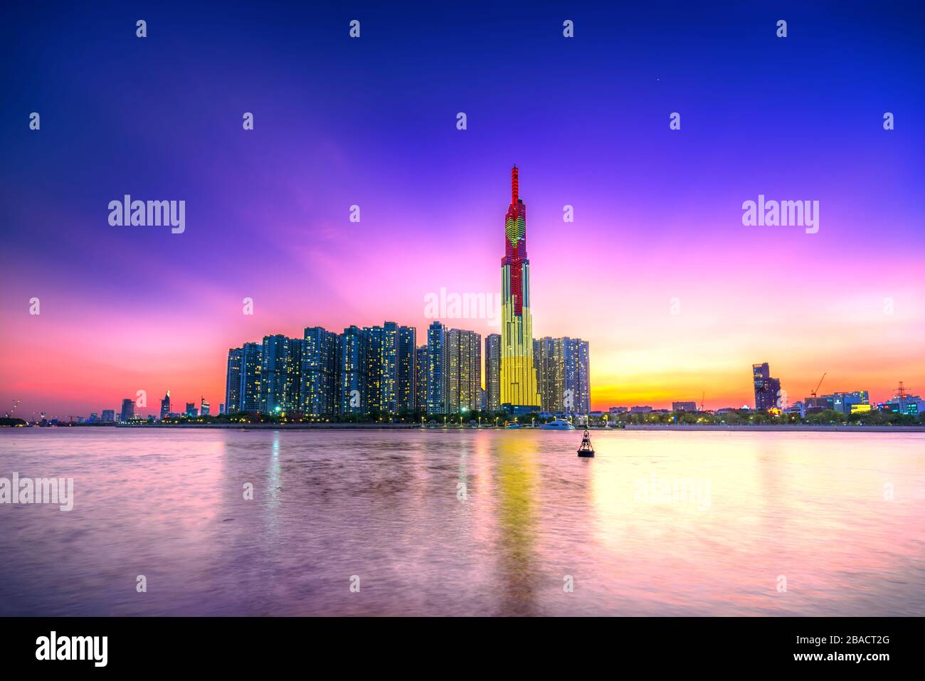 Colorful sunset landscape in a riverside urban area with skyscrapers showing the most economic development in Ho Chi Minh City, Vietnam Stock Photo