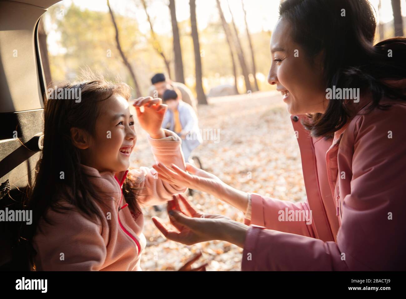 Happy families play outdoors Stock Photo Alamy