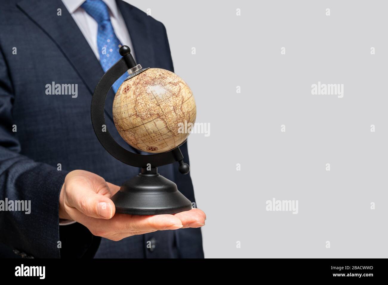 A businessman holding a globe. With copy space. Stock Photo