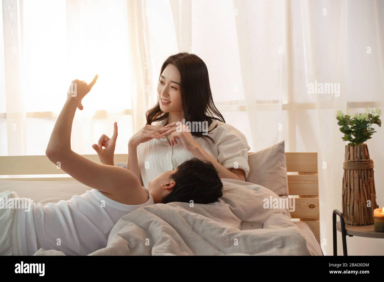 Happy young couple in bed dreaming about new life Stock Photo