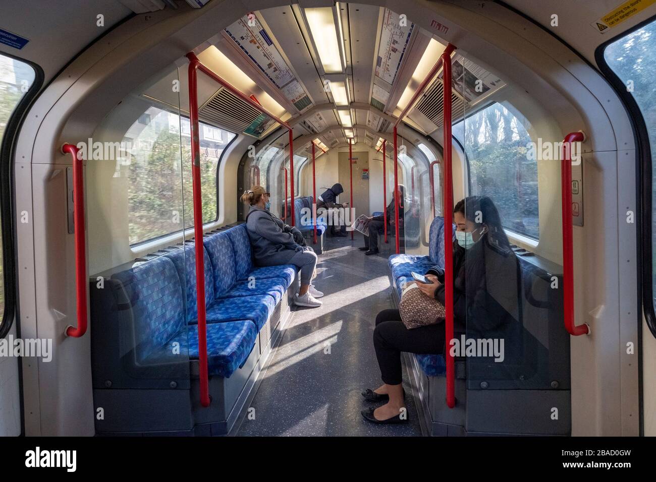 London, UK. 26th Mar, 2020. Passengers travelling on a tube train observe two metres social distancing in London, Britain on March 26, 2020. The British government said on Thursday that the number of confirmed COVID-19 cases in the country has risen to 11,658 as single-day deaths topped 100 for the first time since the outbreak of the disease. Credit: Ray Tang/Xinhua/Alamy Live News Stock Photo