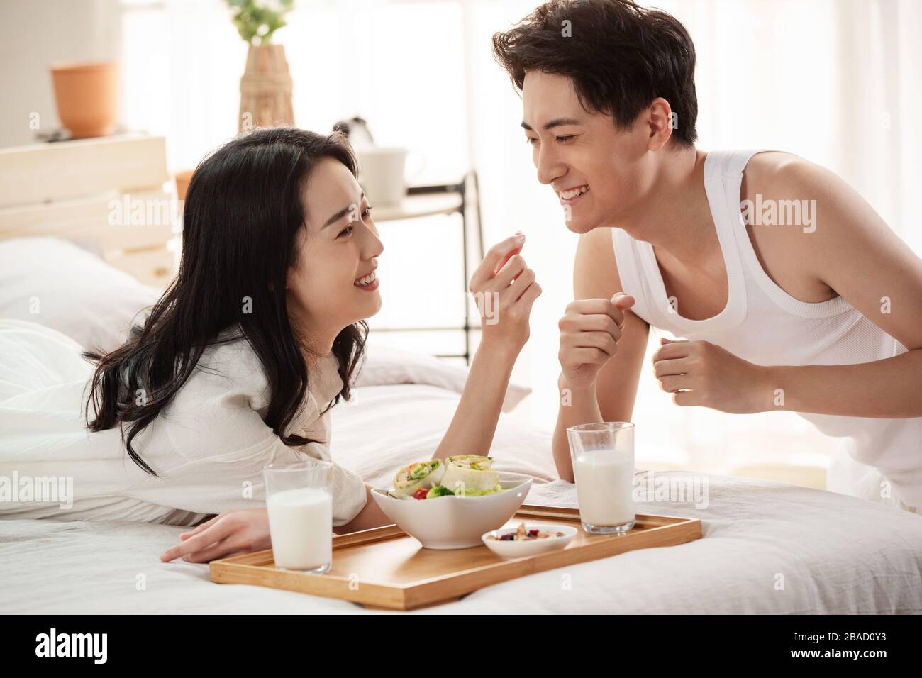 Happy young couple to have breakfast in bed Stock Photo