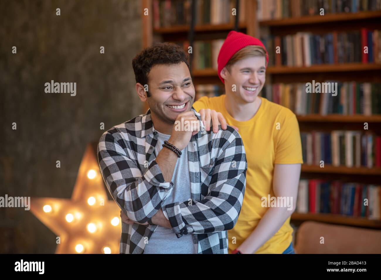 Two young handsome men smiling happily standing in the room Stock Photo ...