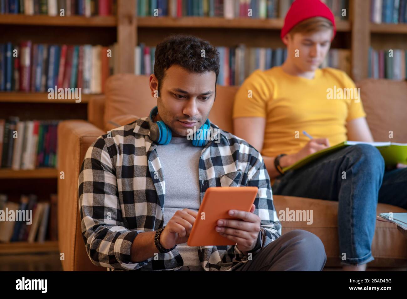 Handsome man in a checkered shirt surfing internet Stock Photo