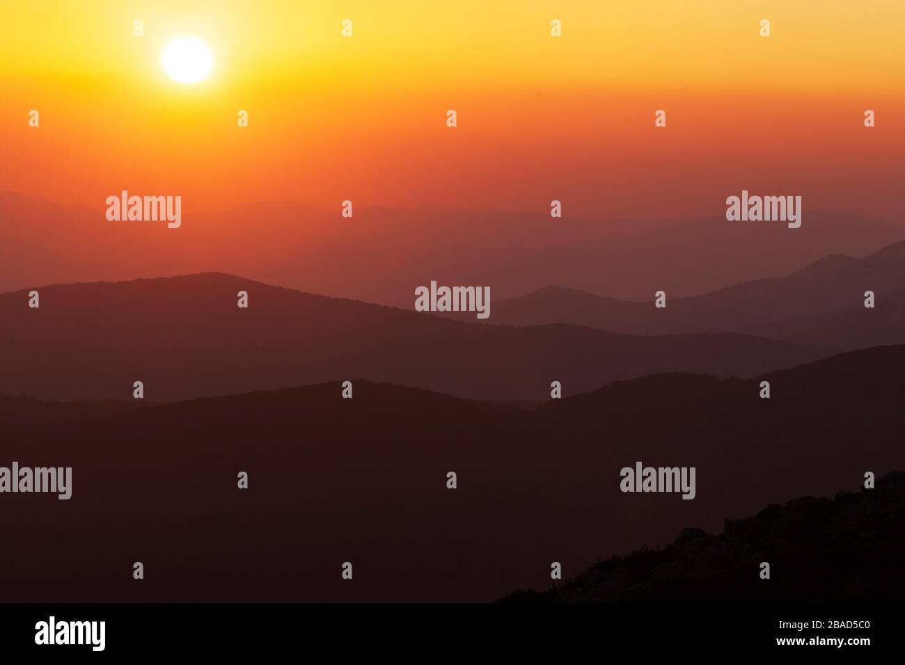 Sunset on the mountain with the layers of the hills Stock Photo - Alamy