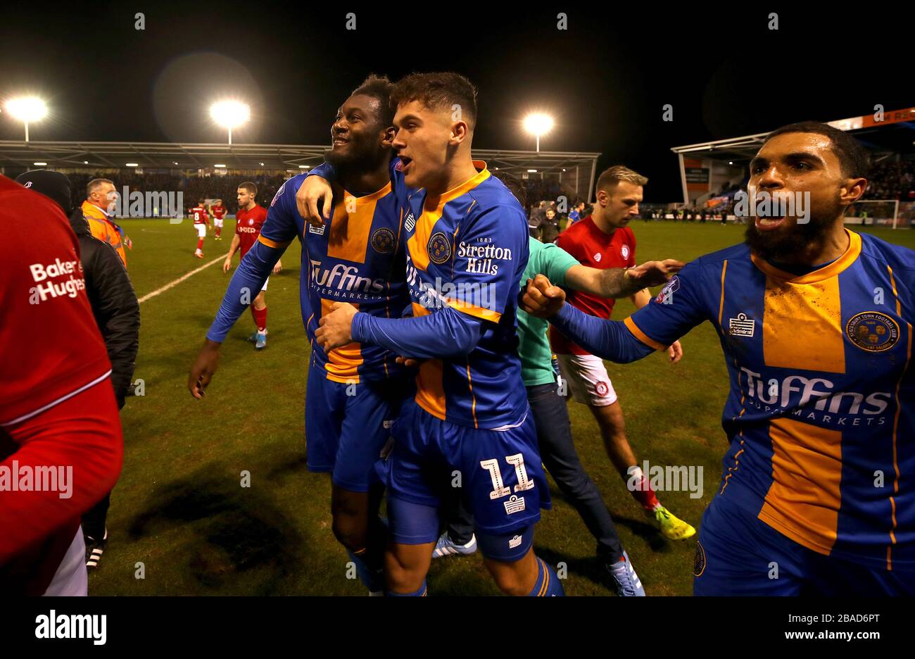 Shrewsbury Town's Aaron Pierre (left) and Ryan Giles (centre) and Scott Golbourne (right) celebrate victory after the final whistle Stock Photo