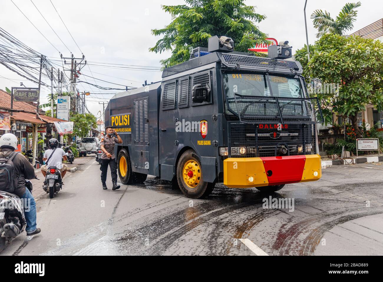 March 27, 2020. Police mobilization unit trucks for spraying disinfectant in Canggu, Bali tourist area. Indonesia. Government virus protection program. Stock Photo