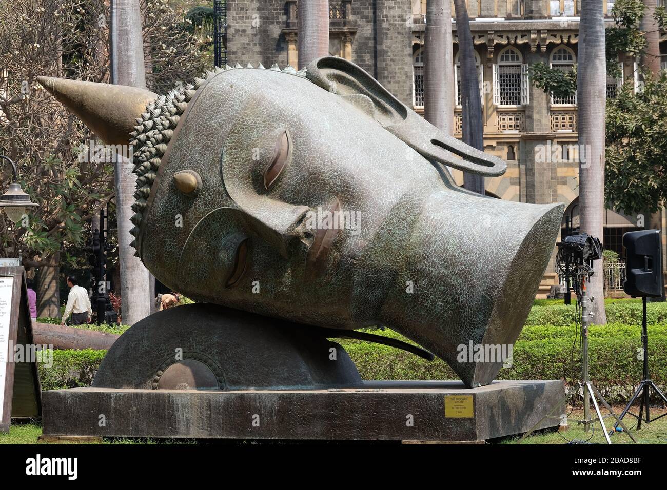 Statue of Buddhas head in the garden of the Prince of Wales Museum, now known as The Chhatrapati Shivaji Maharaj Museum in Mumbai, India Stock Photo