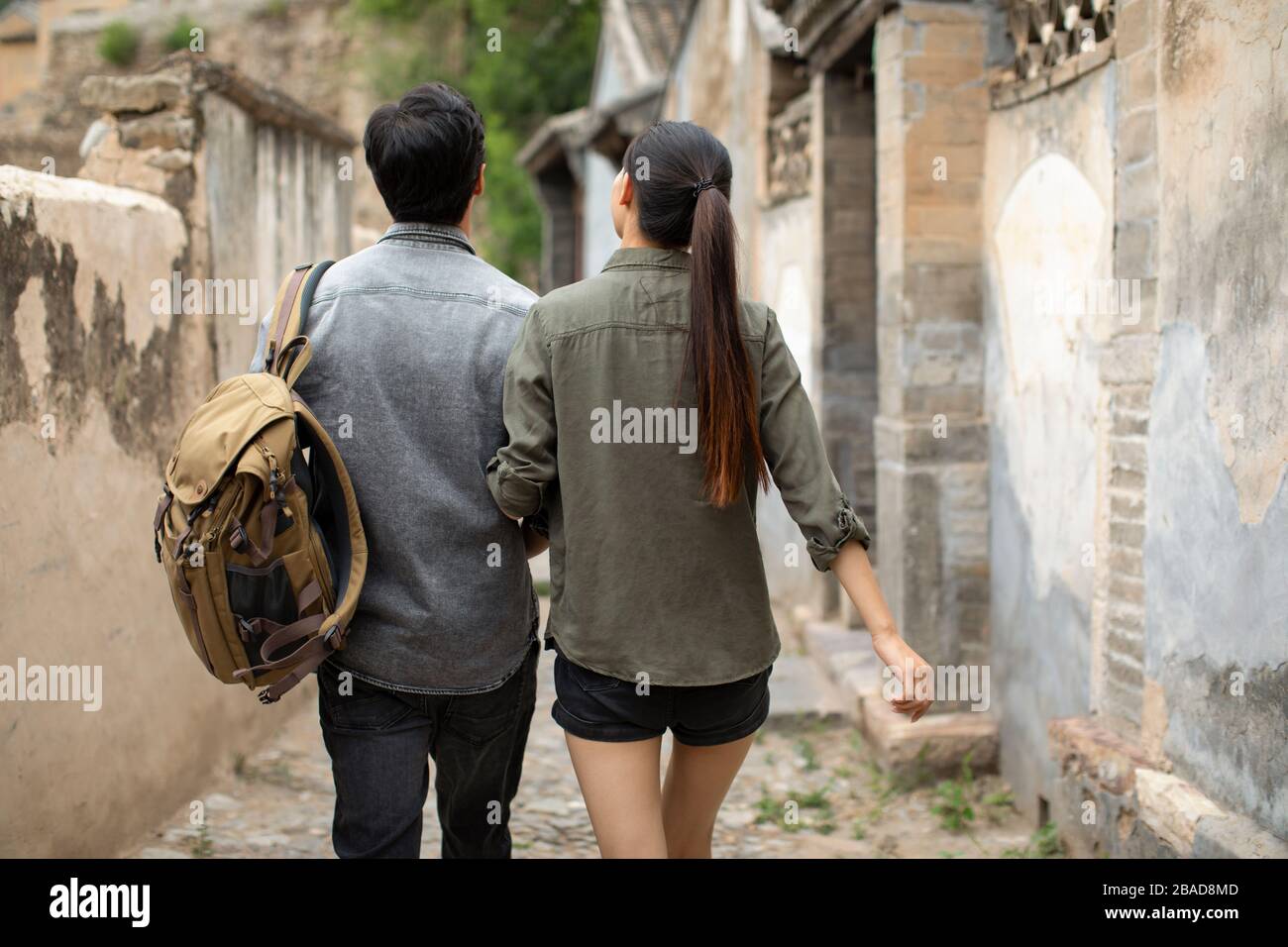 Back view couple walking arm hi-res stock photography and images - Alamy