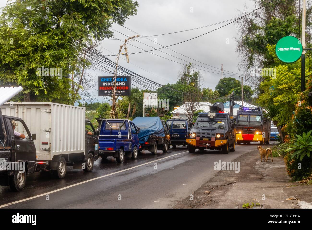 March 27, 2020. Police mobilization units cleaning the roads for spraying disinfectant on the streets of Canggu, Bali popular tourist area. Indonesia. Stock Photo