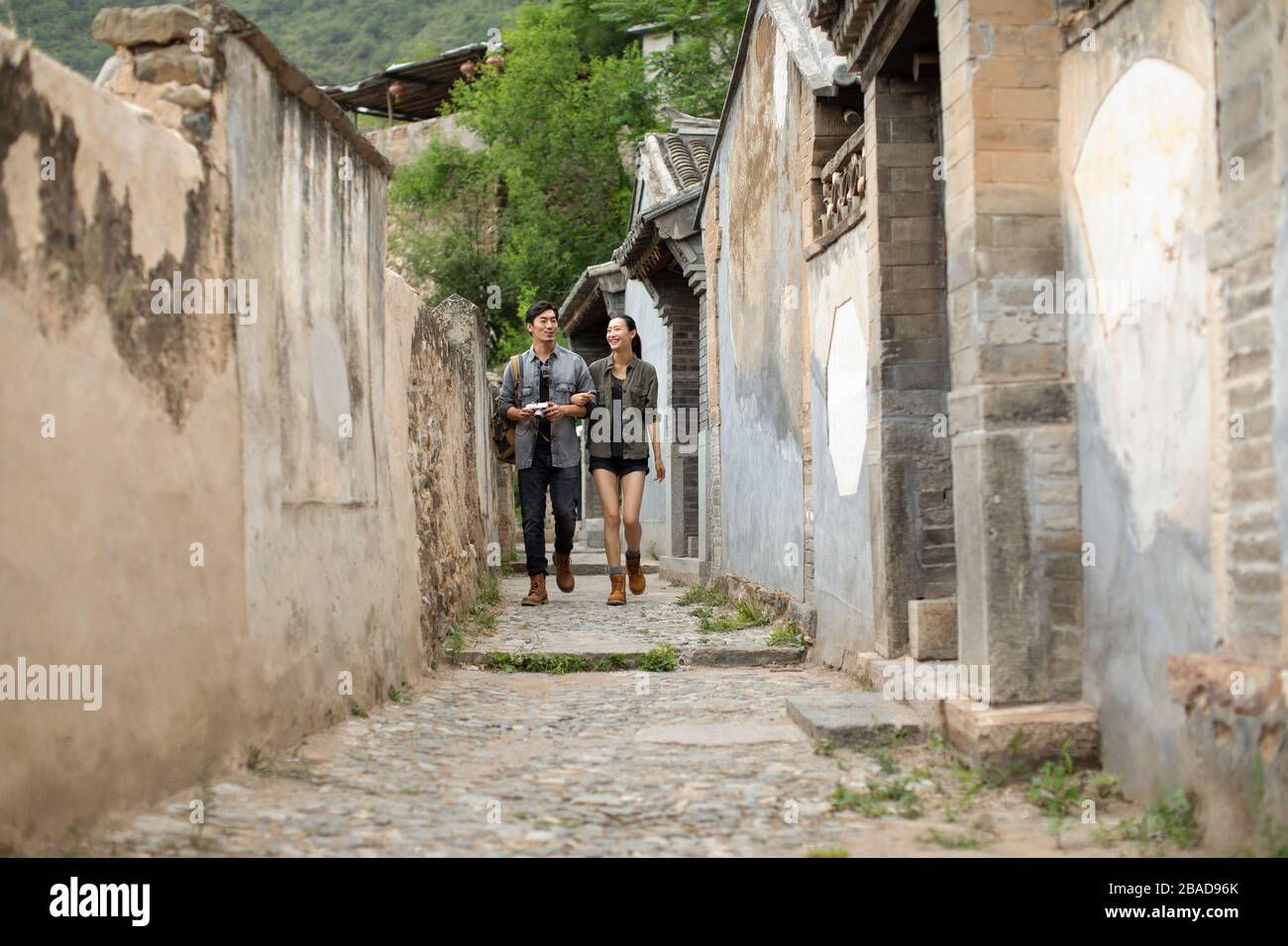 Young Chinese couple walking in village Stock Photo - Alamy
