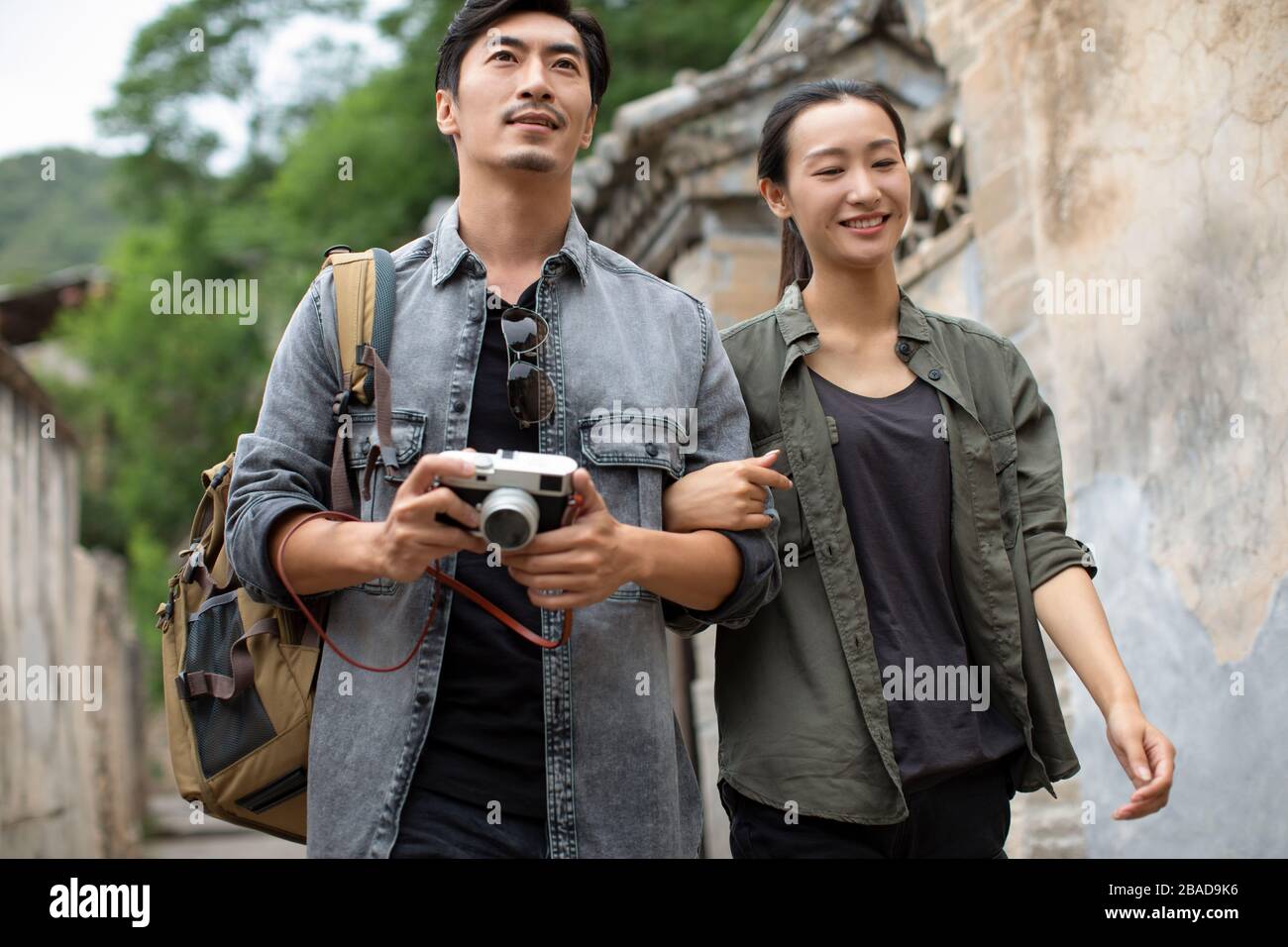Young Chinese couple walking in village Stock Photo - Alamy