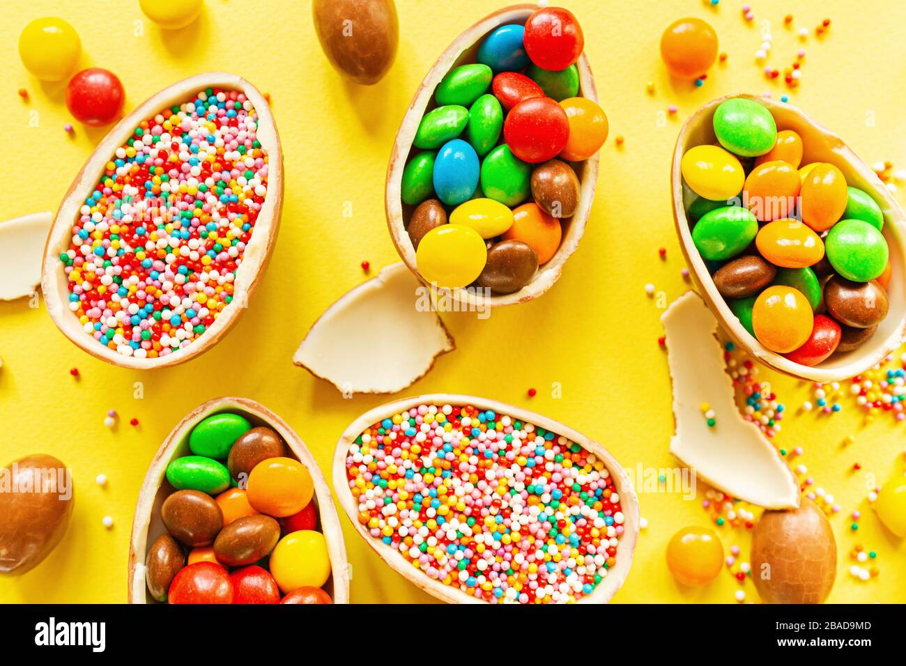 Download Chocolate Easter Eggs And Colorful Candies On Yellow Paper Background Flat Lay Top View Overhead Template Mockup Stock Photo Alamy