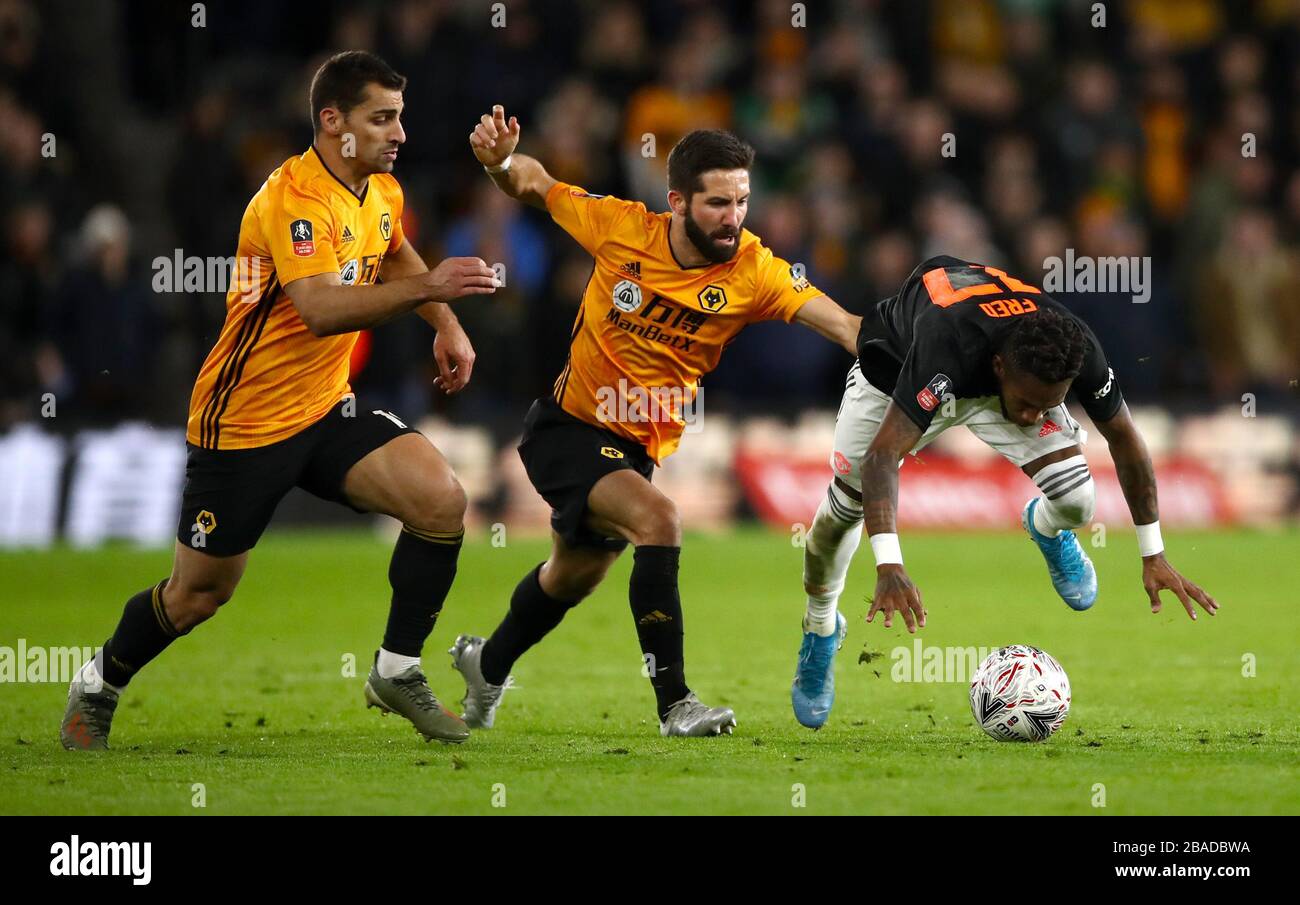 Wolverhampton Wanderers' Joao Moutinho (centre) and Manchester United's Fred battle for the ball Stock Photo