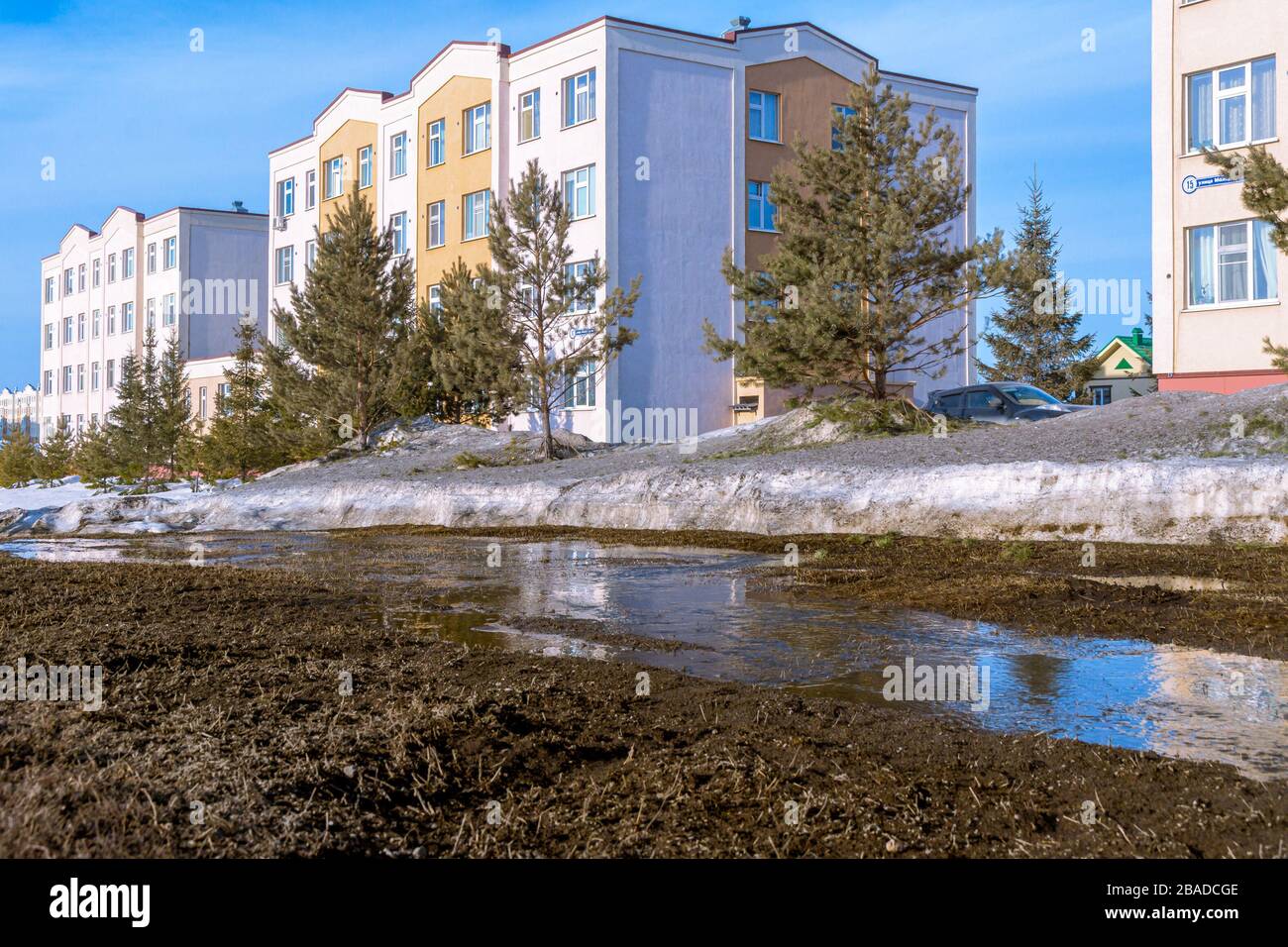 spring streams from snow melting in spring flow among houses, washing away weak soils and washing away the foundation Stock Photo