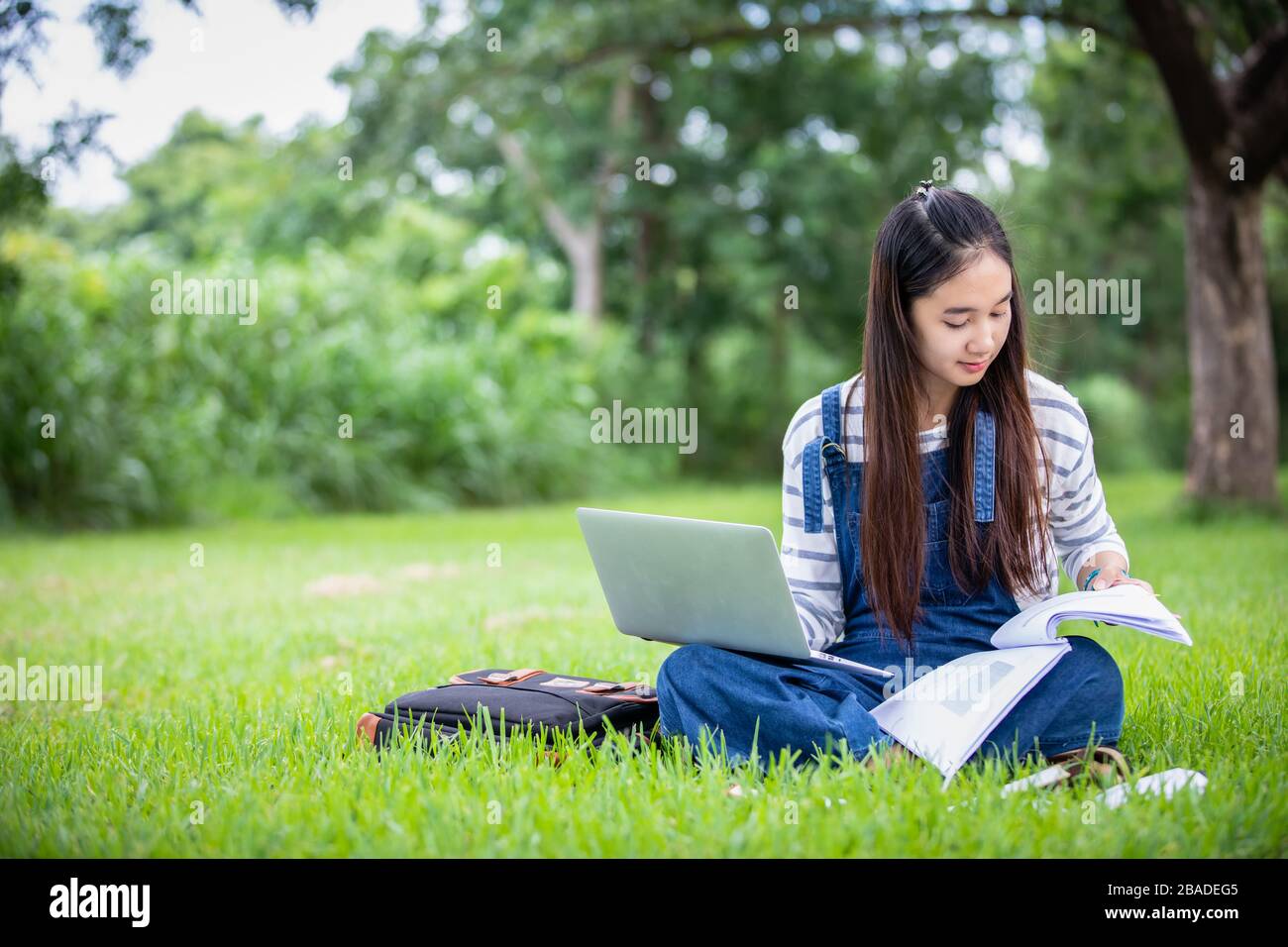 Asian college girl thinking holding hi-res stock photography and images ...