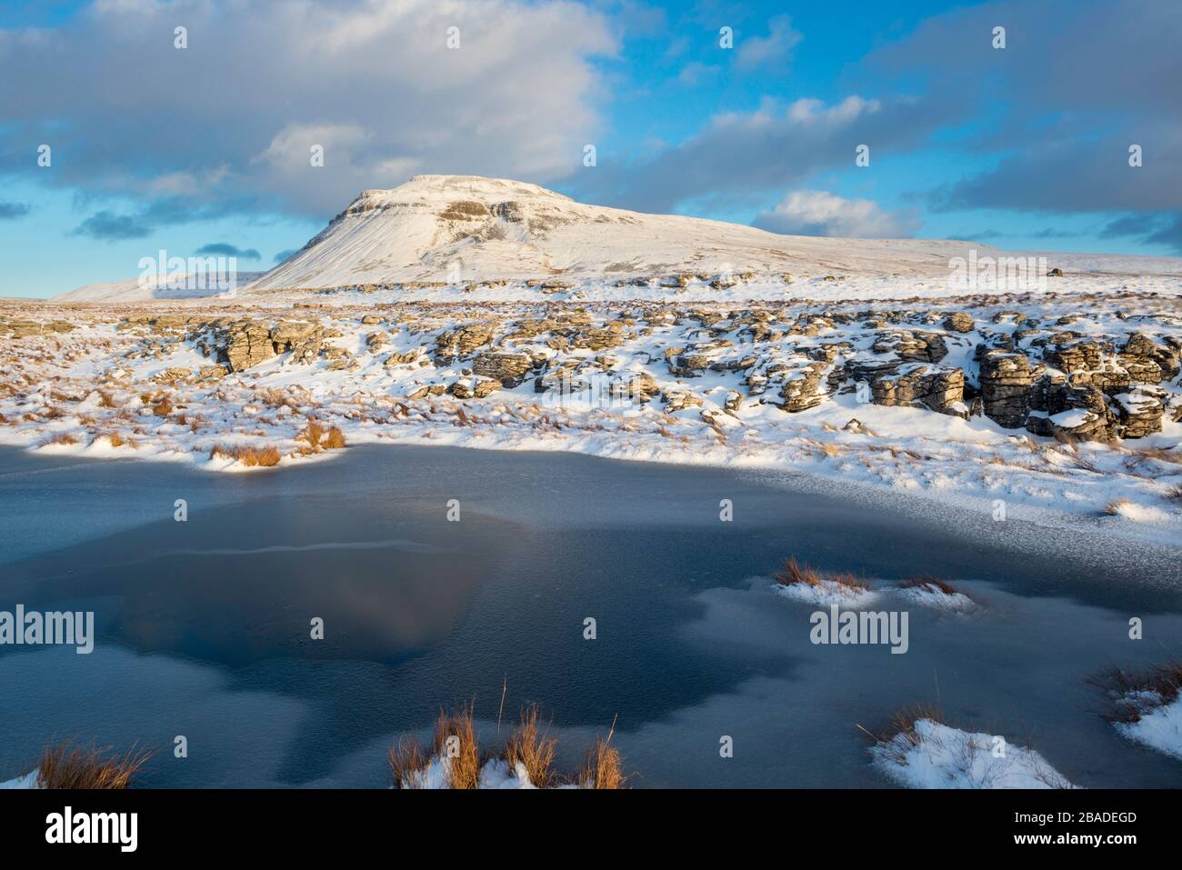 winter view of a snow covered Ingleborough, one of the Yorkshire Three Peaks, seen from White Scars Stock Photo