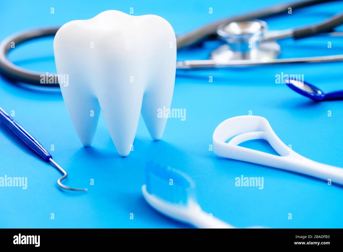 Dental model and dental equipment on blue background, concept image of