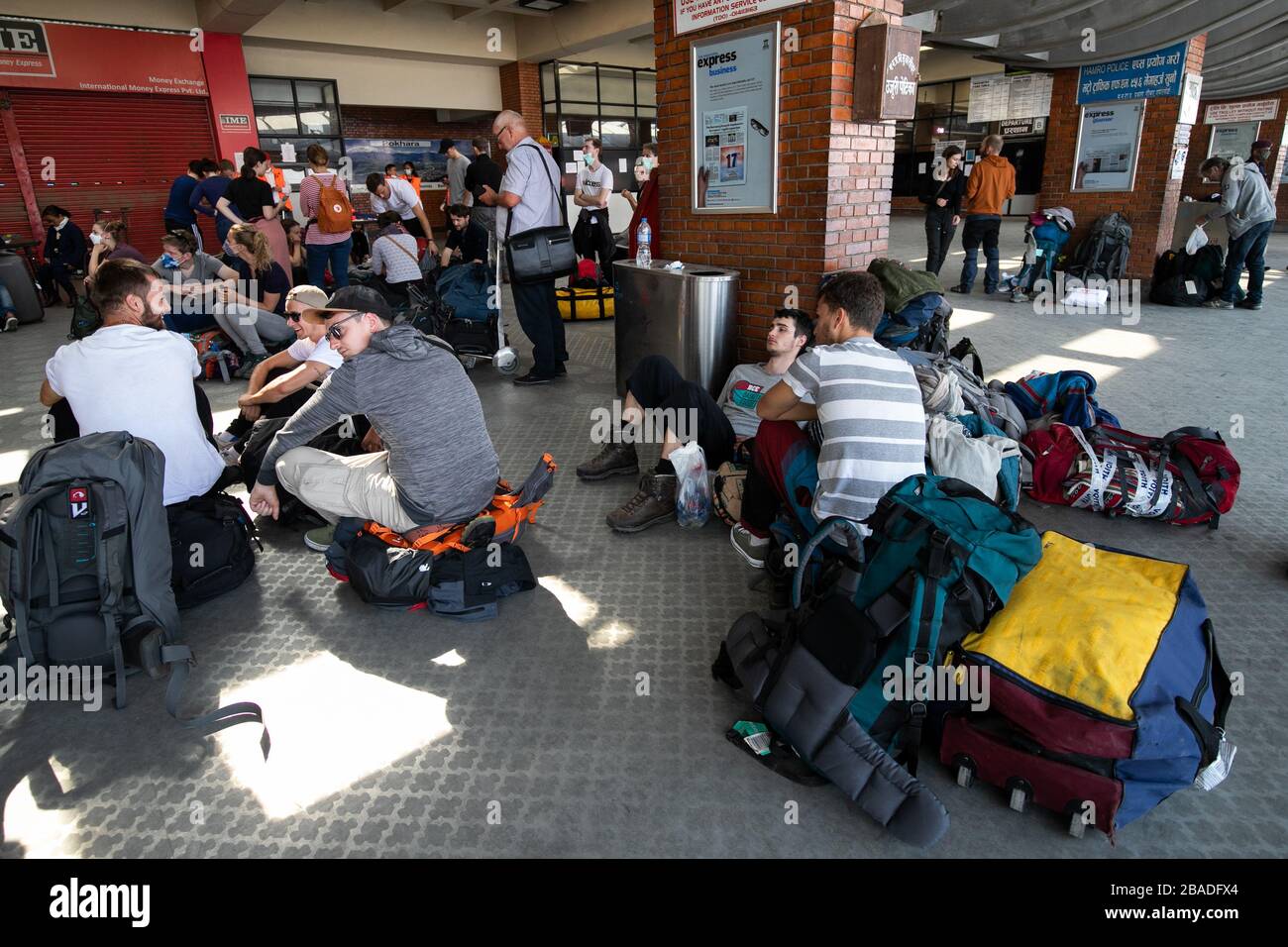 Tourists from Germany who have been stranded in Nepal due to the government-imposed lock down amid concerns over the spread of Coronavirus, wait for their chartered flight back home, at Tribhuvan International Airport in Kathmandu. Stock Photo