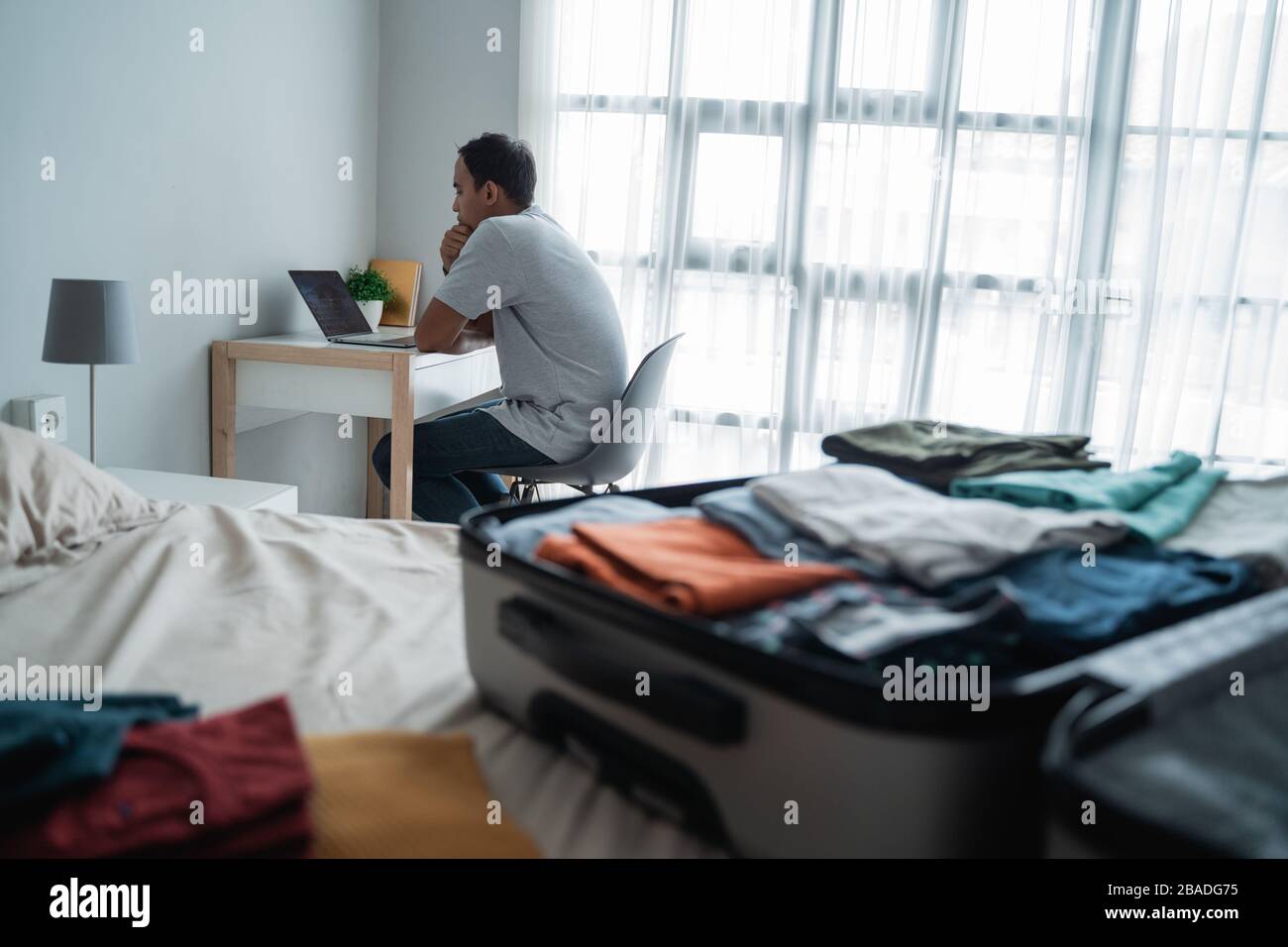 young man traveler using laptop to looking departure schedules via