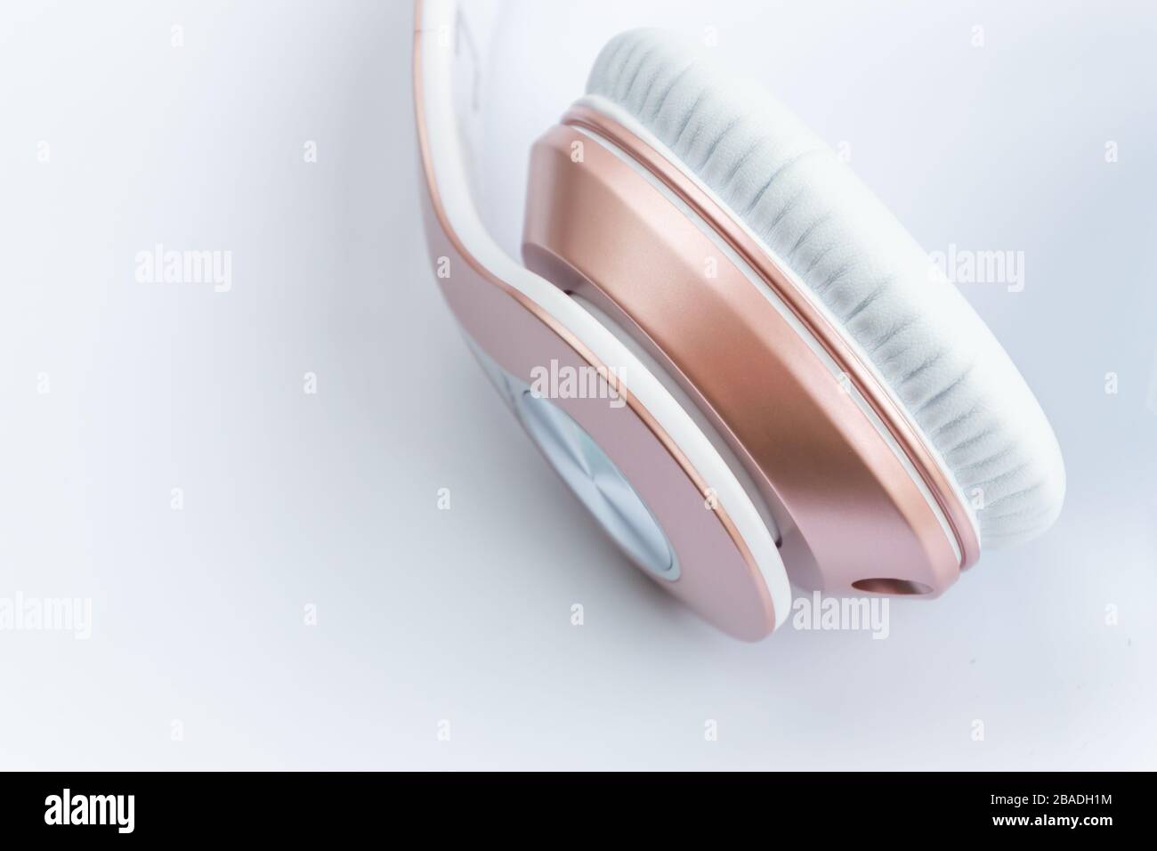 white and gold wireless headphones