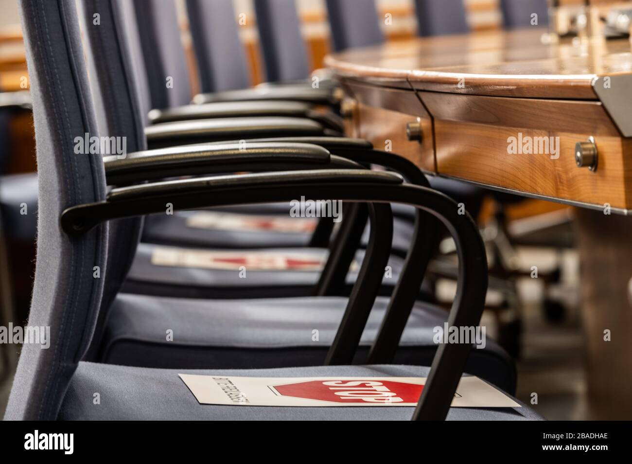 27 March 2020, Rhineland-Palatinate, Mainz: On the chairs of some of the members of parliament there are notices 'Stop Please Release'. Despite the corona crisis, a special session is held in the Rhineland-Palatinate state parliament. Among other things, a supplementary budget due to additional expenditures in the health care system and additional guarantees for state loans to companies are on the agenda. Some of the members of parliament are sitting on the gallery because of the distance regulation, so the quorum and the representation of the majority is ensured. Photo: Andreas Arnold/dpa Stock Photo