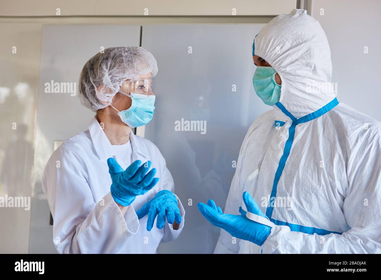 Doctor and nurse in protective clothing in clinic during coronavirus epidemic Stock Photo