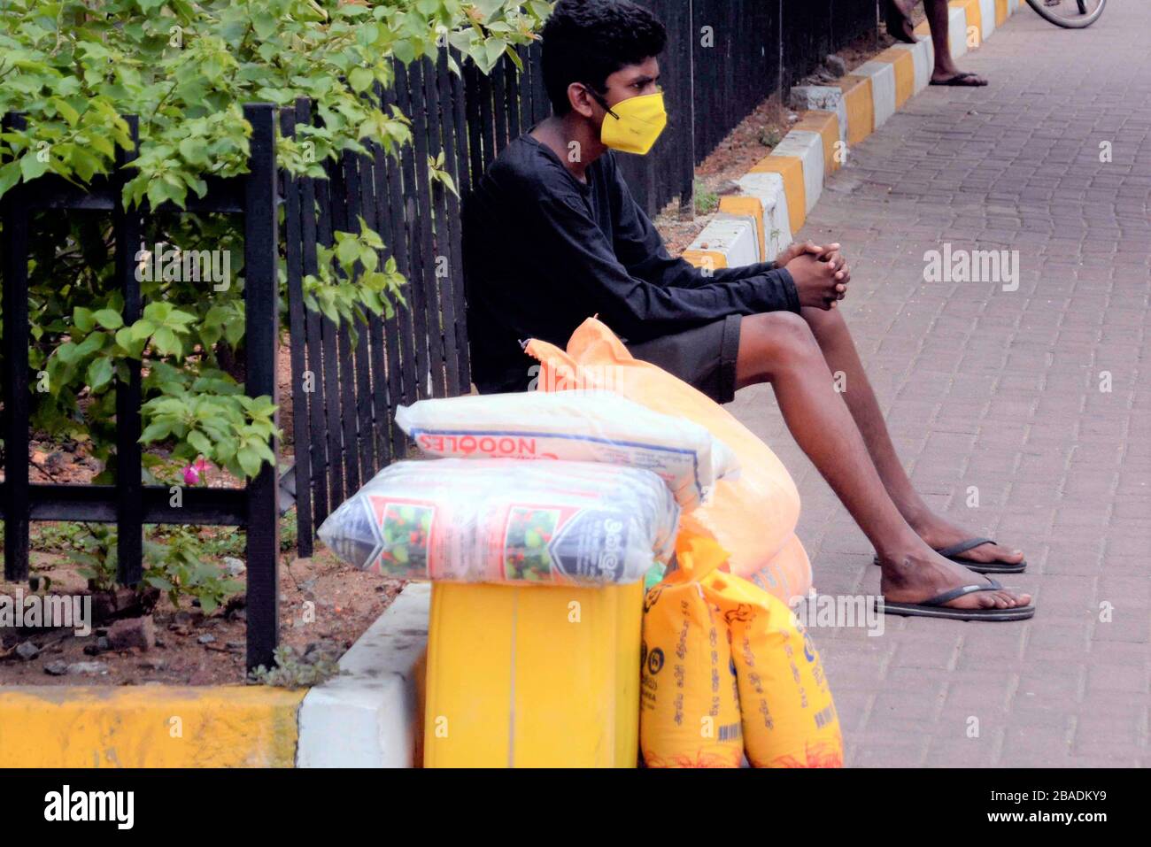 Colombo, Sri Lanka. 26th Mar, 2020. A young boy waits for a vehicle after he purchased goods in Colombo, Sri Lanka, March 26, 2020. Sri Lanka's capital Colombo, Gampaha and remained
