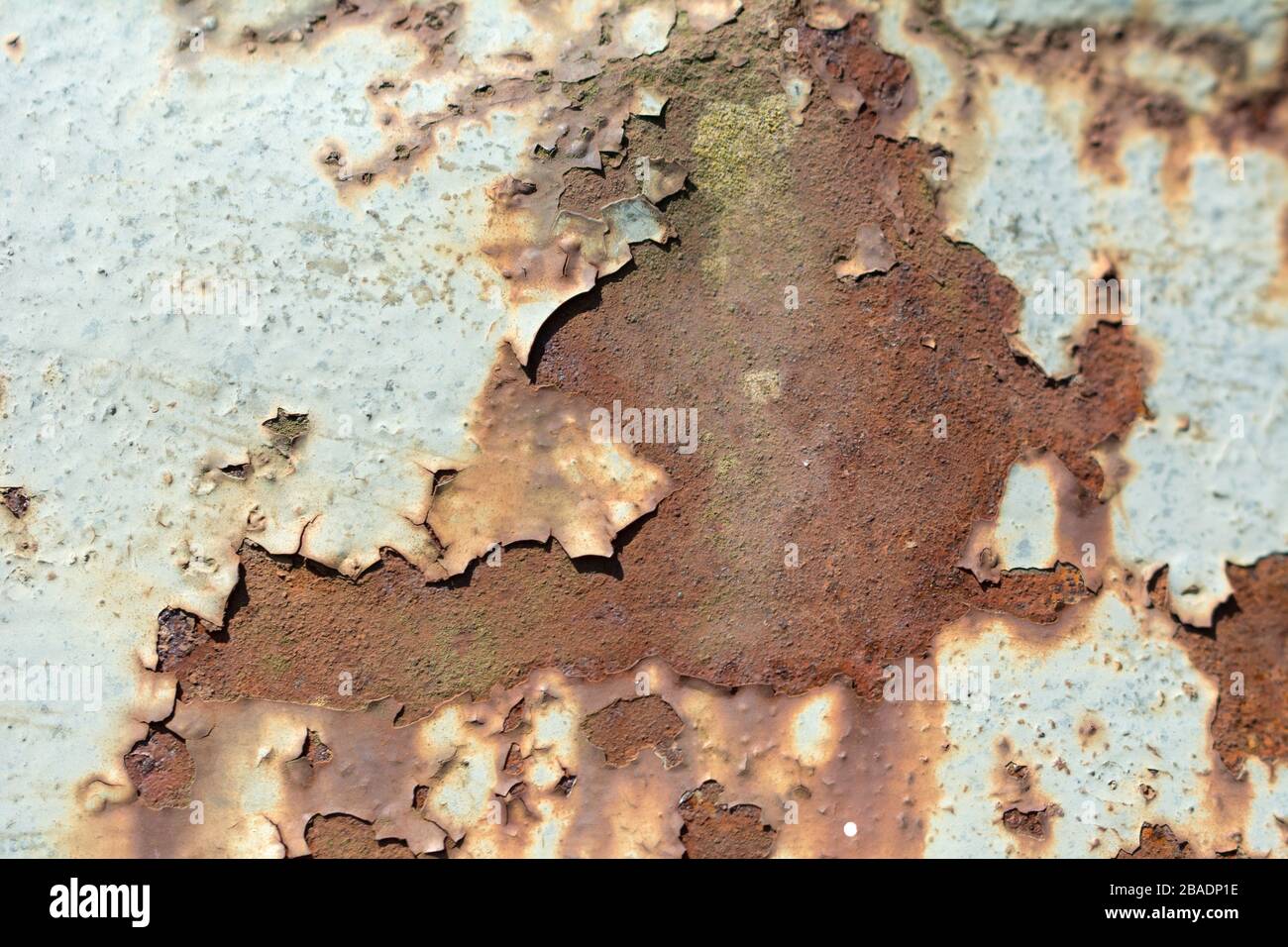 Rusty metal surface with flaking old white paint Stock Photo