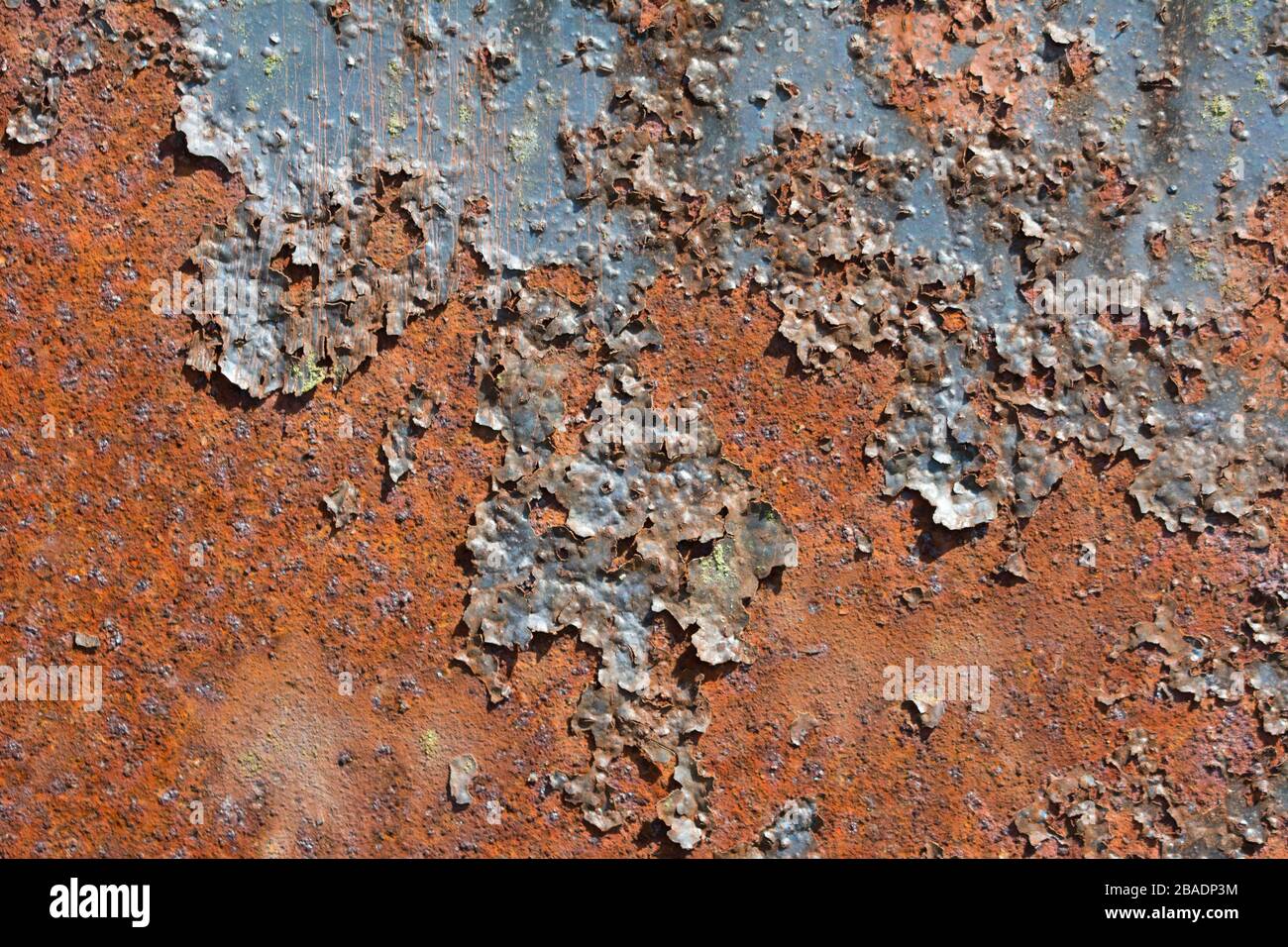 Rusty metal surface with flaking old dark paint Stock Photo