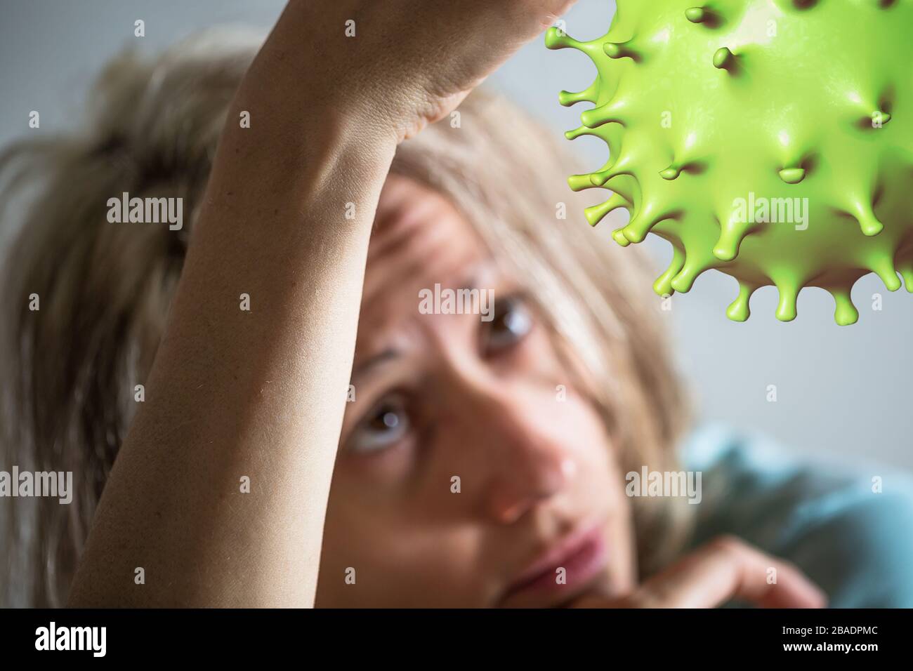 Coronavirus cell and patient woman in quarantine for COVID-19 on blurred background. Depression, stress, suicidal thoughts and psychological problems Stock Photo