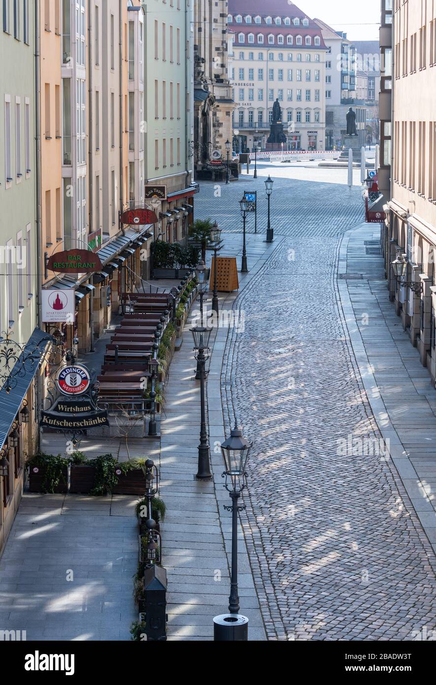 Dresden, Germany. 25th Mar, 2020. The Münzgasse to Neumarkt is deserted. To contain the coronavirus, Saxony now bans all accumulations of three or more people in public. Credit: Robert Michael/dpa-Zentralbild/dpa/Alamy Live News Stock Photo