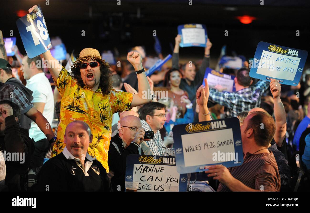 Darts fans celebrate a 180 between Dean Winstanley and Kevin Painter. Stock Photo