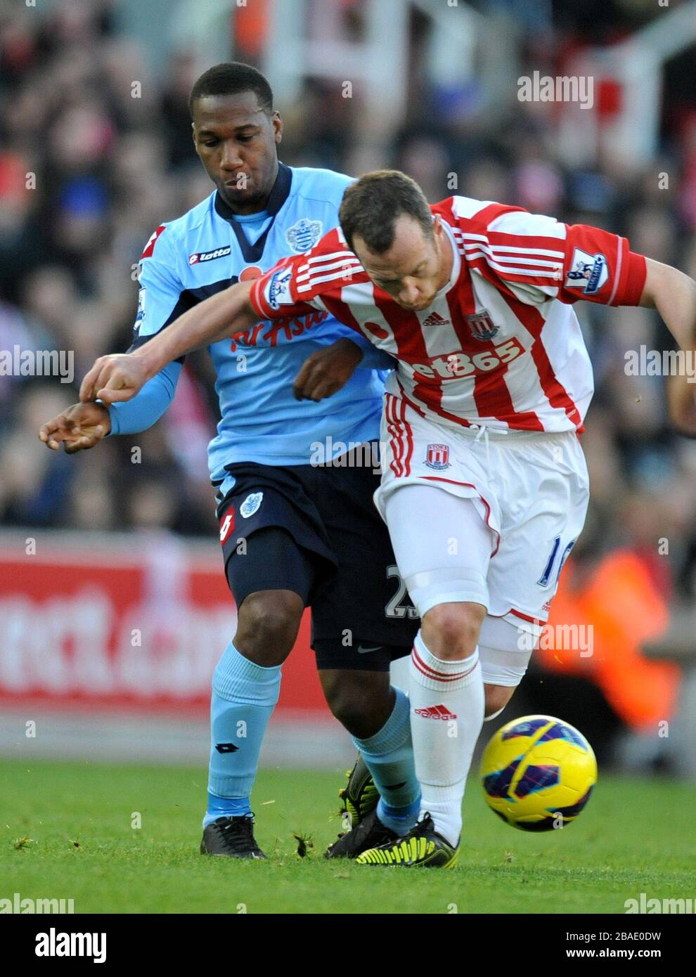 Stoke City's Charlie Adam is fouled by Queens Park Rangers' Junior Hoilett Stock Photo