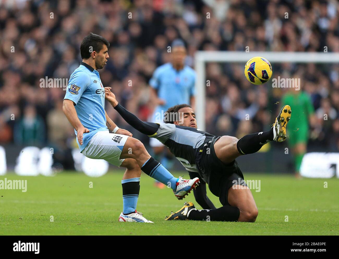 Tottenham Hotspur's Tom Huddlestone (right) slides in on Manchester City's Sergio Aguero (left) Stock Photo