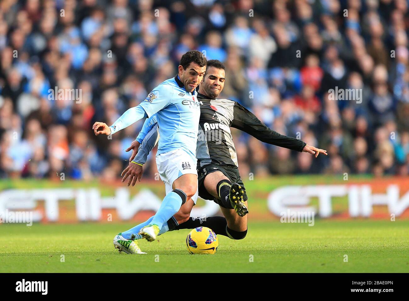 Tottenham Hotspur's Raniere Sandro (right) slides in on Manchester City's Carlos Tevez (left) Stock Photo