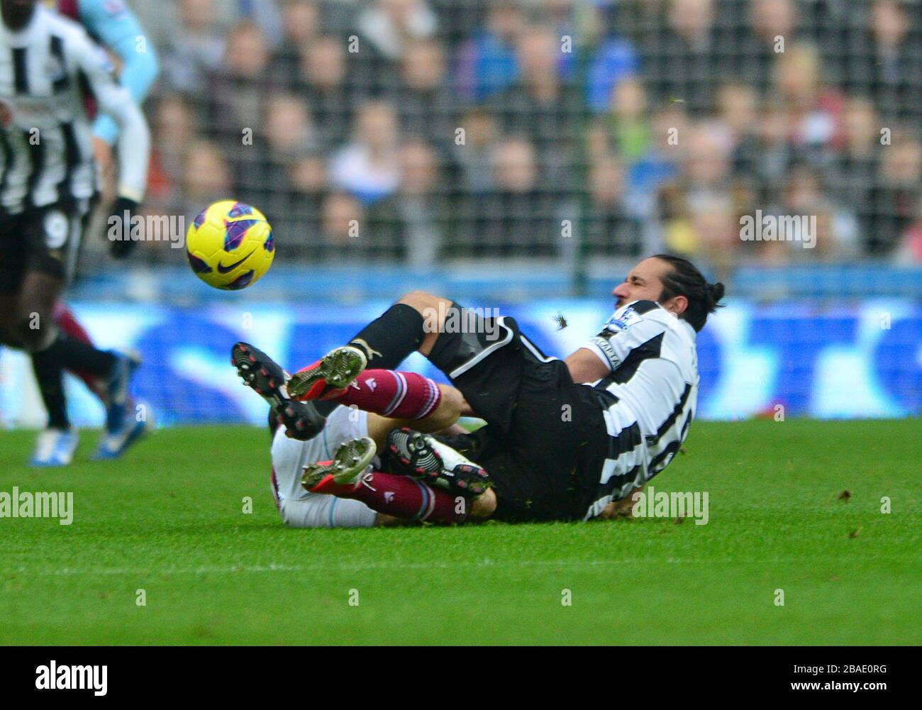 Newcastle United's Jonas Gutierrez (right) clashes with West Ham United's Yossi Benayoun (left) as they battle for the ball Stock Photo