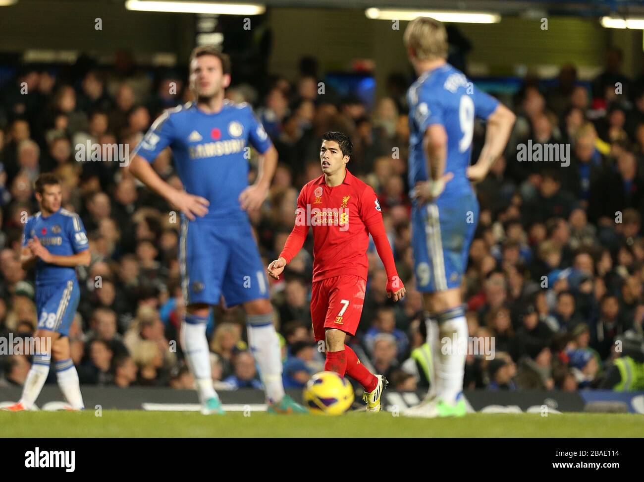 Chelsea's Juan Mata and Fernando Torres wait to restart the match after Liverpool's Luis Suarez (centre) scores his team's opening goal Stock Photo