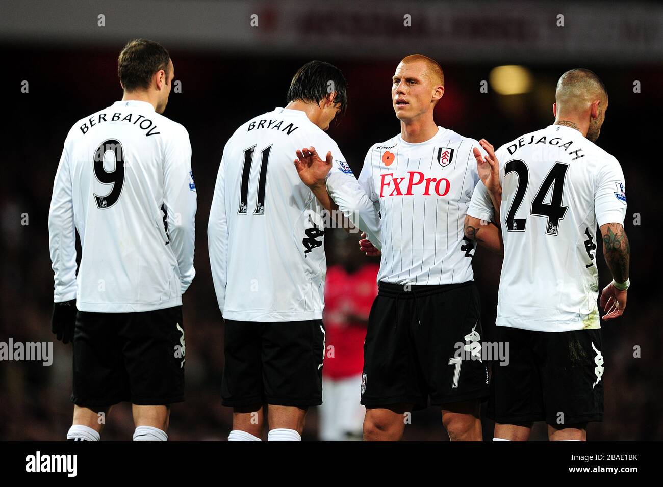 Fulham's Steve Sidwell is walked backwards by teammates Stock Photo