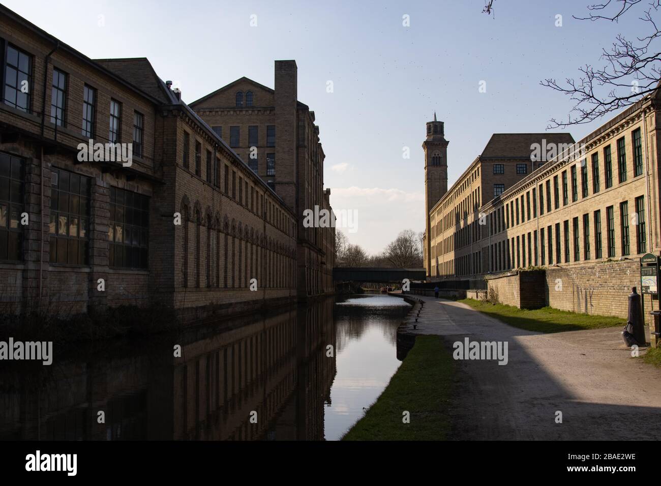 SALTAIRE, ENGLAND - 25/3/2020 - Salts Mill (left) shown parallel to New Mill (right) separated by the canal between them, during the COVID-19 lockdown Stock Photo