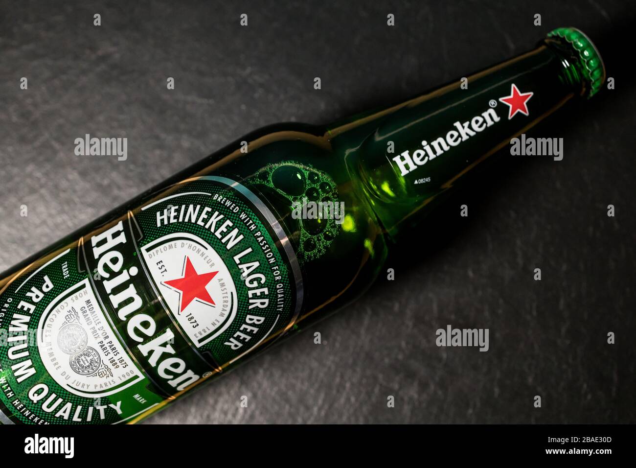 LONDON - MARCH 11, 2020: Heineken lager beer bottle on dark background Stock Photo