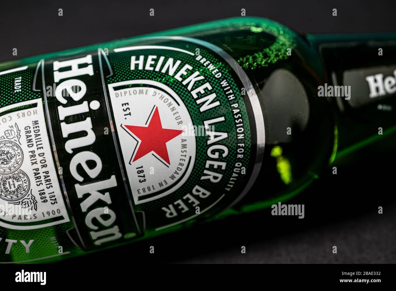 LONDON - MARCH 11, 2020: Heineken lager beer bottle on dark background Stock Photo