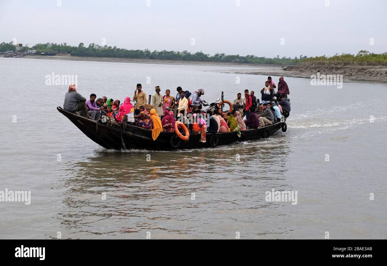 Wooden boat crosses the Ganges River in Sundarbans, West Bengal, India ...