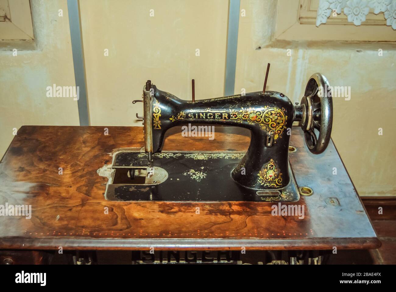 Vintage Singer sewing machine threaded with spool of white thread on white  Stock Photo - Alamy