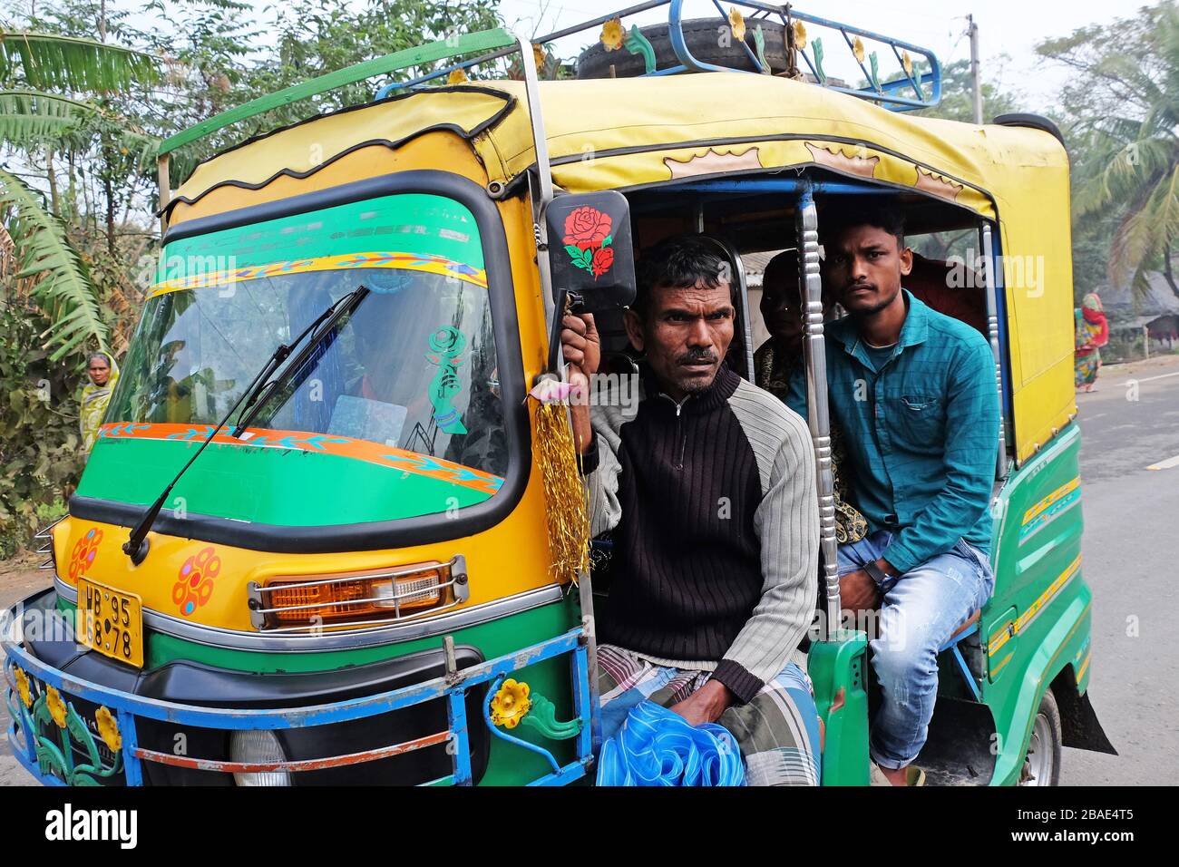 Indian tricycle motor rickshaw carrying passenger, Kumrokhali, West