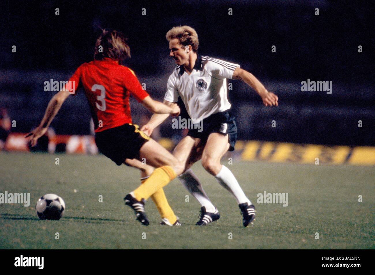 West Germany's Karl-Heinz Rummenigge (r) takes on Belgium's Luc Millecamps (l) Stock Photo